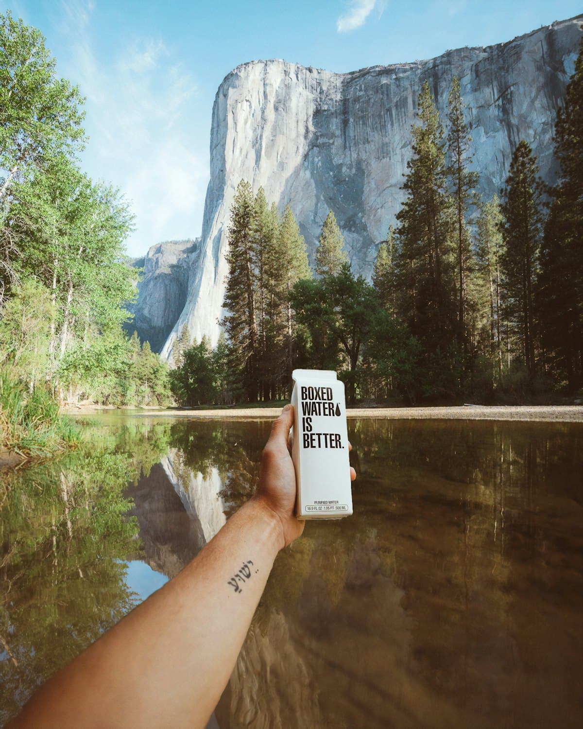 Reusable water carton held up against a valley