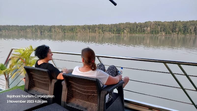 Guests relaxing on the cruise deck overlooking the forest
